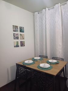 a dining room table with two plates on it at Cê Achegue Aqui Uai in Contagem