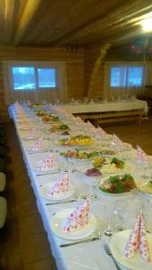 a long table with plates of food on it at Vizbulites in Pulkarne