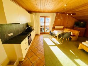 a kitchen and dining room with a table and a dining room at Haus Plattenkar in Obertauern