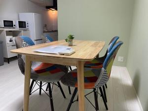 a wooden table and chairs in a kitchen at Modern House Fukufuku Hanaten in Osaka