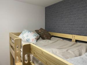 a wooden bunk bed with two pillows on it at Modern House Fukufuku Hanaten in Osaka +10 photos