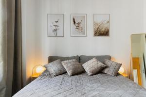 a bedroom with a bed with four pictures on the wall at FamilienZeit Apartments in Bremerhaven