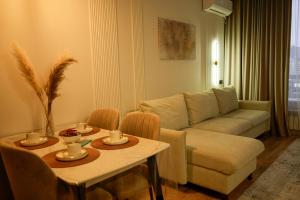 a living room with a couch and a table at Apartments on Khan Shatyr in Astana +192 photos