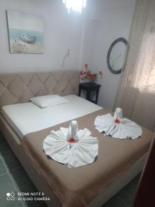 A bed or beds in a room at "By The Sea" Family apartments