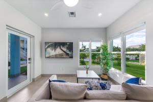 a living room with a couch and a table at Affordable Luxury Apartments, 3 Min to Beach in West Bay