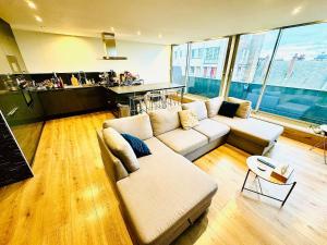 a living room with a couch and a table at Suite Lucia 90m2 avec vue - 2 chb in Dunkerque