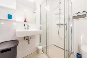 a bathroom with a sink and a shower at Holiday House Libra in Jadrija +18 photos
