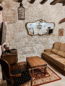 a living room with a couch and a table and a mirror at Les sorciers de Lauzerte immersion magique in Lauzerte