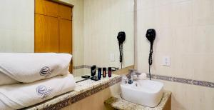 a bathroom with a sink and a phone and towels at Hotel Consulado in Guadalajara +36 photos