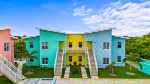 a colorful apartment building with colorful houses at Affordable Luxury Apartments, 3 Min to Beach in West Bay