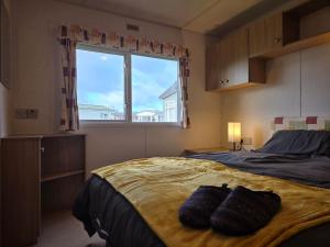 a bedroom with a bed with two pillows on it at Elf Wood Lodge - Swimming Spa, Sky Sports, Tennis, Hadrian's Wall listing in Port Carlisle +52 photos