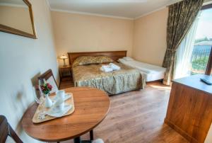 a hotel room with two beds and a table at Villa Meridian in Trzęsacz +37 photos