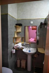 a bathroom with a sink and a mirror at T-point Apartments in Lekki