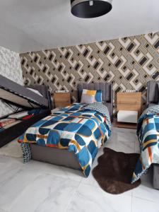 a bedroom with a bed and a wall at Sirine57 Charming House for 5 Guests Large Private Parking for Cars Vans in Florange