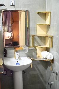 a bathroom with a sink and a mirror at T-point Apartments in Lekki +15 photos