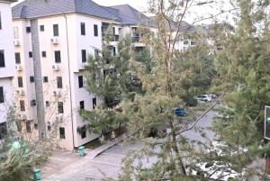 an aerial view of a building with trees at T-point Apartments in Lekki