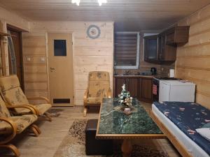 a kitchen with a christmas tree on a table at Domek nad Stawem in Istebna
