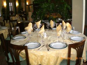 a table with plates and wine glasses on it at Magnagallo in Campogalliano