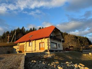a small house with an orange roof on a field at Садиба Сикитура in Verkhneye Vodyanoye