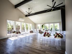 a room with chairs and tables with flowers on them at MT House Luxury Private Estate Experience 5 Acres 20 Min KCI Downtown KC in Liberty