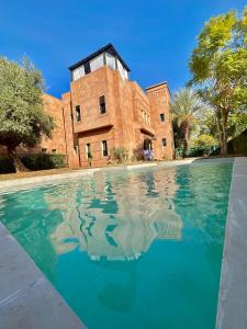 a pool of water in front of a building at Private Riad Alemania in Marrakesh - Pool - Rooftop in Marrakech