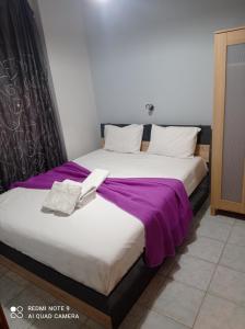A bed or beds in a room at "By The Sea" Family apartments