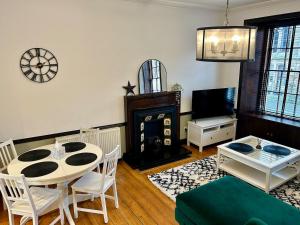 a living room with a table and a couch at Number 30 Crossgate in Fife