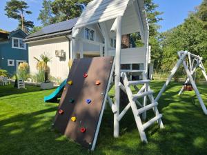 a playground with a climbing frame and a slide at KANALOA in Pobierowo