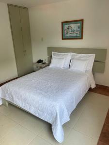 a bedroom with a large bed with white sheets and pillows at Hotel Mar del Plata in Cartagena de Indias +47 photos