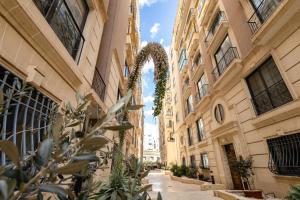 a street in the city with buildings and a plant at Elegant central apartment in Sliema