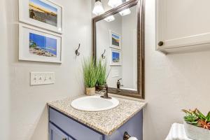 a bathroom with a sink and a mirror at Sauna, Hot Tub and Cold Plunge Oklahoma City Home! in Oklahoma City +29 photos