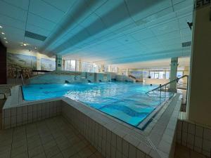 a large swimming pool in a large building at Casa Köstner in Sankt Englmar