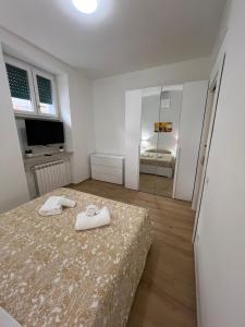 a bedroom with a bed with two towels on it at Roma Cento new apartment in Rome