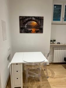 a white table and chairs in a room at Roma Cento new apartment in Rome