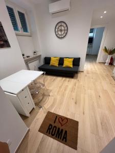 a living room with a rug that says i love roma at Roma Cento new apartment in Rome +1 photo