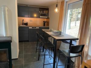 a kitchen with a table and some chairs and a window at Stellar Mátra in Mátraszentimre