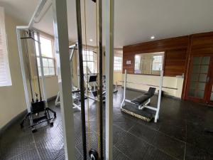 a gym with two treadmills and a mirror at Suites Fazenda Muriqui in Vila Muriqui
