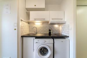 a kitchen with a washing machine and a sink at La Cigale Varoise - Hyères La Plage in Hyères +24 photos