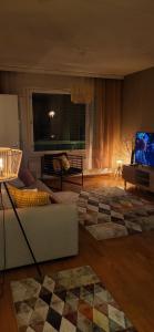 a living room with a couch and a flat screen tv at Great apartment in Vantaa Close to the airport, with Sauna! in Vantaa