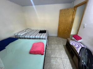 a small room with two beds in it at Casa gravata de penha in Penha
