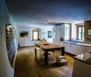 a kitchen with a wooden table and chairs in it at LA PRUNETINA, Mugello Serene Country Residence near Florence in Florence +23 photos