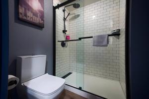 a bathroom with a glass shower with a toilet at MOXY New Orleans Downtown/French Quarter Area in New Orleans