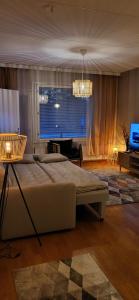 a bedroom with a large bed and a television at Great apartment in Vantaa Close to the airport, with Sauna! in Vantaa
