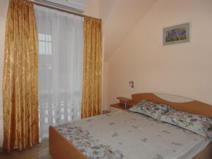 a bedroom with a bed and a large window at Tashevi Apartments in Pomorie