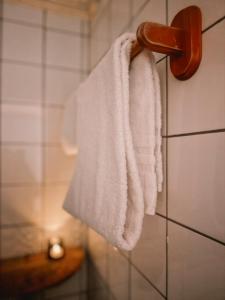 a towel hanging on a wall in a bathroom at Finnholmen Brygge in Henningsvær +85 photos
