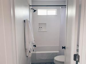 a white bathroom with a toilet and a shower at Beautiful Private Guest House in Arcadia in Phoenix +23 photos