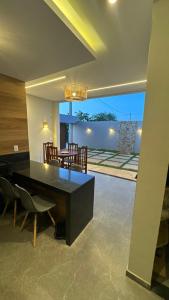 Un comedor con una mesa y sillas negras. en Casa AL Mar - Praia do Preá, en Prea