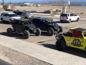 a couple of atvs parked in a parking lot at Hotel Villa Vittas Resort in Bahía de los Ángeles