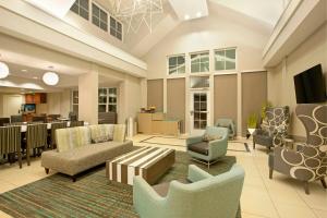 a large lobby with chairs and a living room at Residence Inn Jackson Ridgeland in Ridgeland
