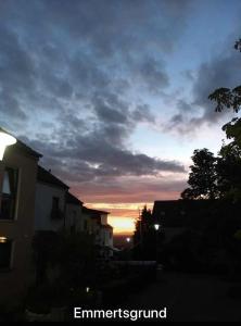 a sunset in a city with buildings and a sky at Privatzimmer im 1 OG in einem Reihenhaus mit gemeinschaftlichen Zimmern in Heidelberg +5 photos